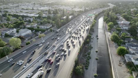 Freeway-rush-hour-traffic-of-car,-sunset-in-Los-Angeles,-aerial-above