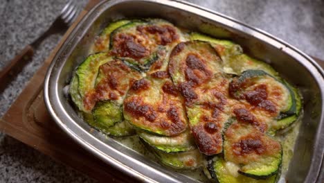 Top view of vegetarian dish with baked green squash and melted cheese