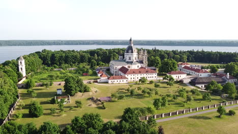 pazaislis monastery complex building with majestic dome in fly away aerial view