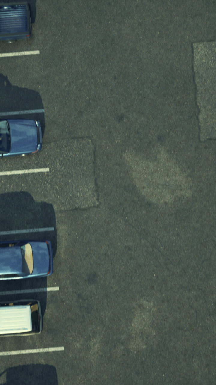 Overview of a busy parking lot filled with various parked vehicles