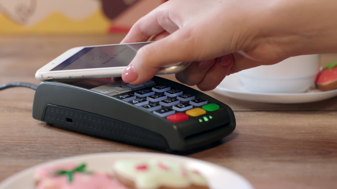 Mobile NFC payment for order in cafe. customer paying through mobile phone