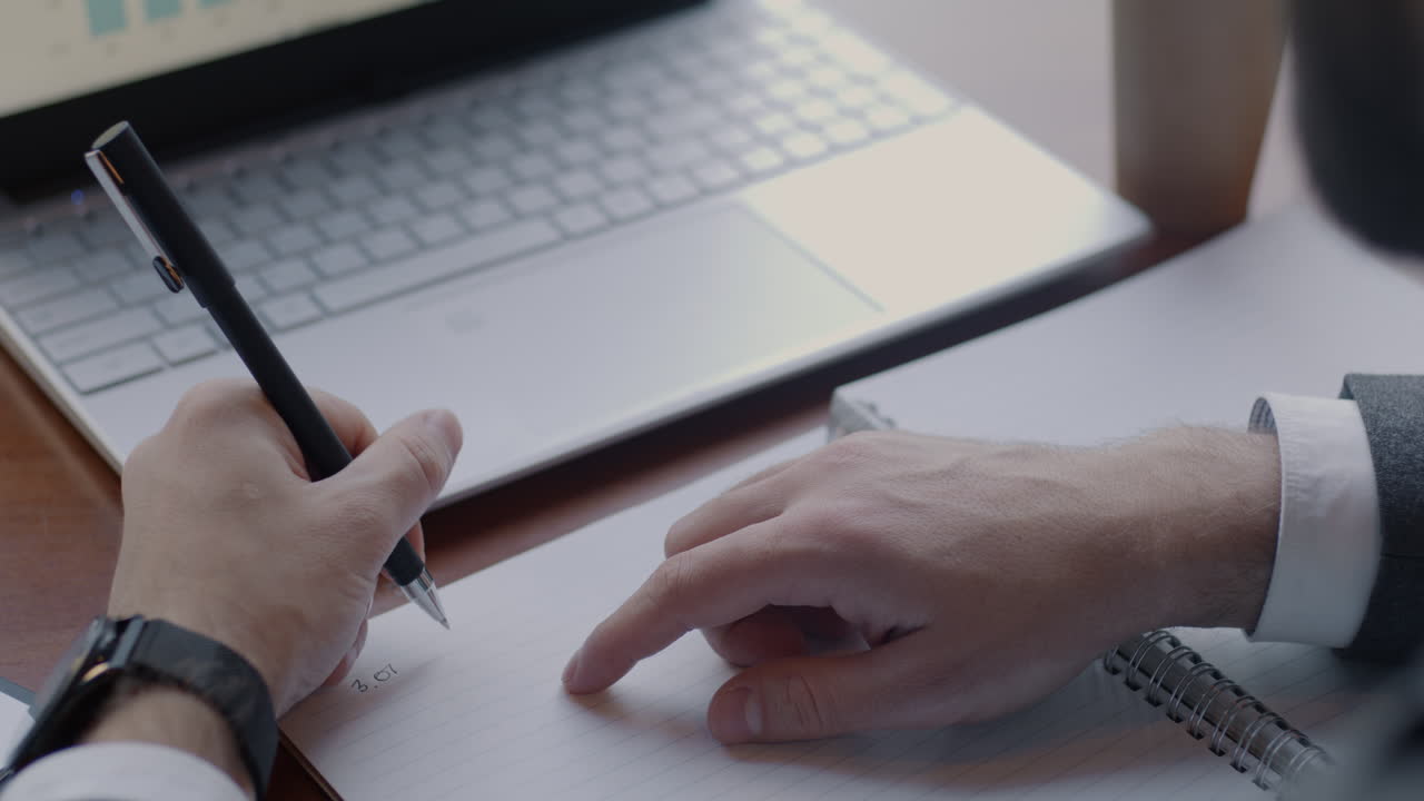 Business Person Taking Notes During a Meeting