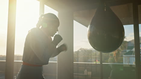 woman boxing workout in a sunny gym