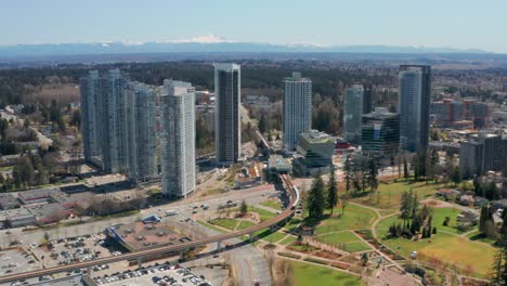 aerial view of a skytrain in motion at king george station in uhd in surrey bc canada
