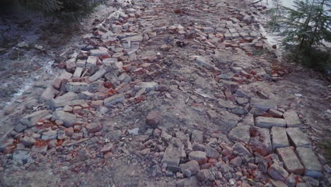 demolished road with broken bricks and debris