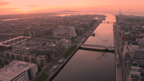 aerial dawn view of dublin city, sunrise in the irish capital of dublin creates a golden hue over the city