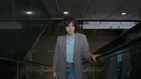 woman walking on an escalator in a metro station