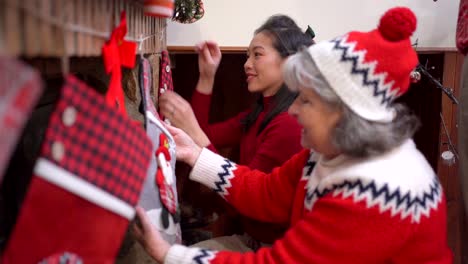 positive diverse women decorating fireplace together