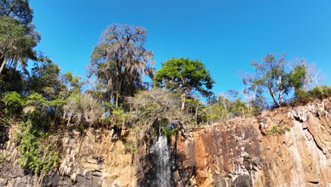 waterfall at scenic gorge canyon. peaking waterfall landscape. nature background. waterfalls cascade at gorge canyons background. geologycal formation ecosystem. waterfalls landscape