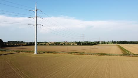 view from the drone of a new light pylon for the passage of high voltage electricity in countryside landscape and traffic car highway - increase in the cost of electricity energy  and green revolution