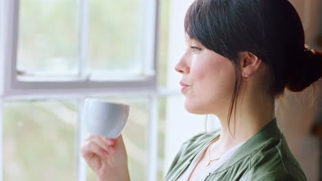 Morning,-coffee-and-woman-drinking-by-window-to