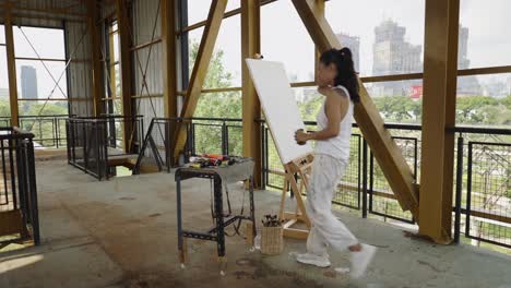 an artist arranges supplies before painting outdoors