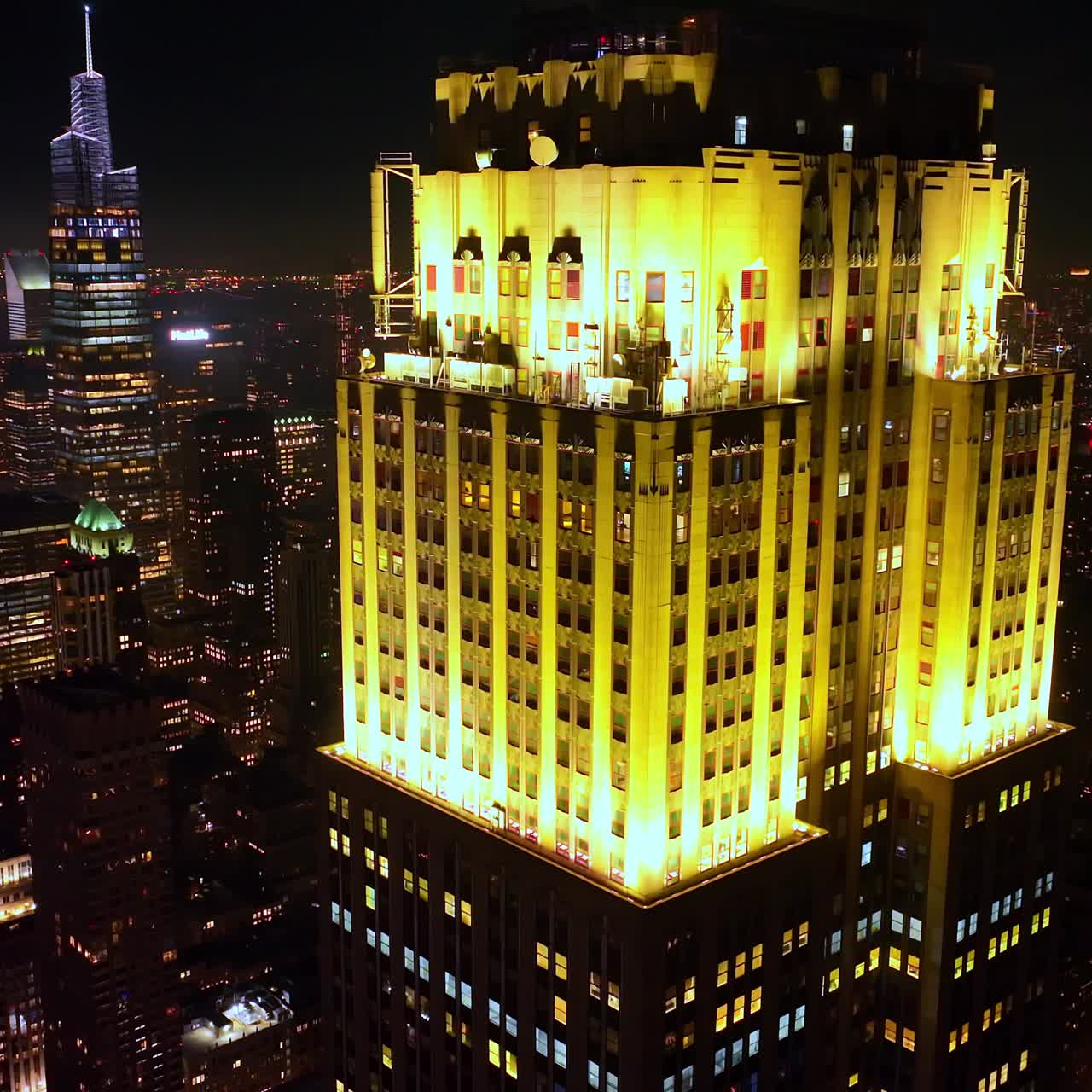 Amazing beautifully-lit top of a skyscraper in New York. Startling cityscape of metropolis at night. Top view