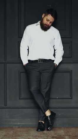 gentleman posing in studio. portrait of stylish handsome man with beard in studio vertical video