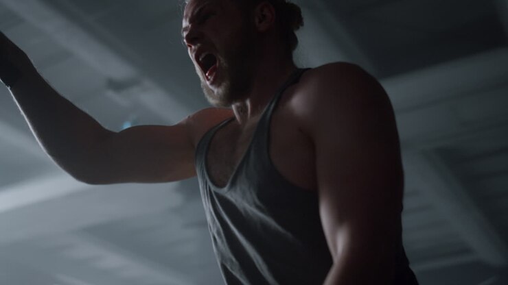 Sportsman working with battle ropes. Fitness man having intensity training