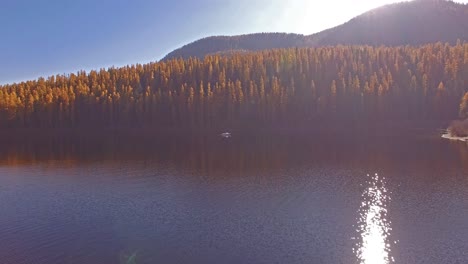 Aerial-Drone-Shot-in-Montana-on-a-lake-with-a-boat-in-the-Fall-or-Autumn