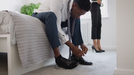 business couple in bedroom getting ready for work businesswoman at home putting on shoes