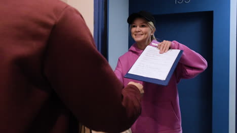 delivery woman with paper bags and a clipboard