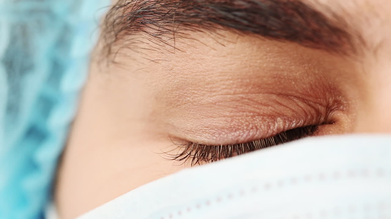 외과의사의 가까운 눈. 눈을 열고 있는 남자