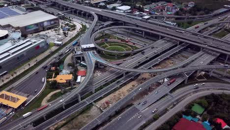 drone footage of highway road junctions. the intersecting freeway road overpass the eastern outer ring road of bangkok, thailand.