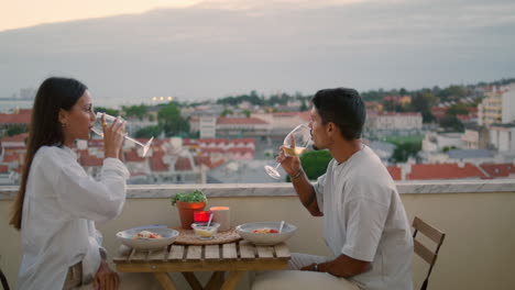 Positives-Paar-Feiert-Date-Bei-Sonnenuntergang-Auf-Der-Terrasse,-Nahaufnahme.-Familie-Stößt-Mit-Gläsern-An