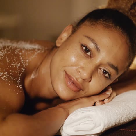 Woman-Lying-On-Massage-Table-With-Salt-Scrub