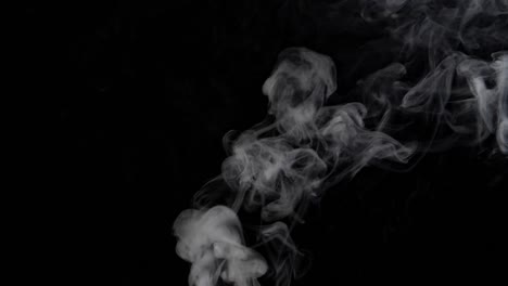 slow motion water mist puff stream over black background, slow motion