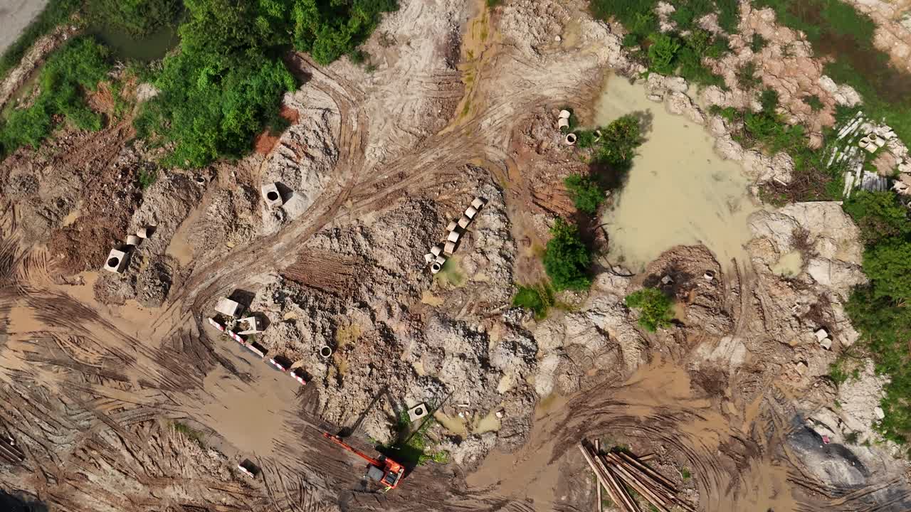Aerial view of an active construction site with excavation, infrastructure, and heavy machinery