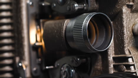 Makro-Nahaufnahme-Eines-8-mm-Filmstreifens,-Der-Durch-Einen-Alten-Analogen-8-mm-Vintage-Projektor-Läuft