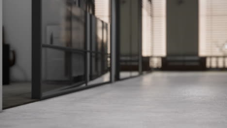 light spills across a concrete corridor in a modern building during daytime