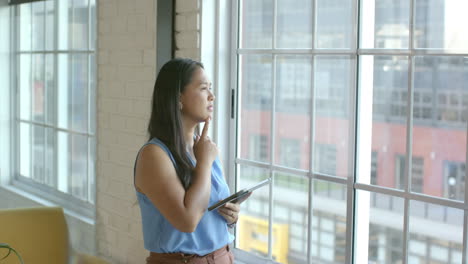 Biracial-woman-ponders-a-business-problem-in-a-bright-office