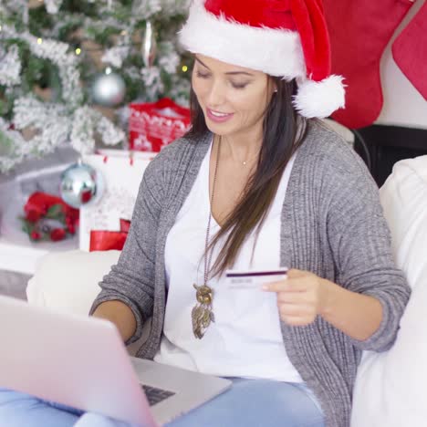 happy young woman making online xmas purchases