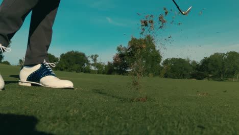 slow motion golf shot from side, wedge shot from clean fairway lie on sunny day in 4k push in