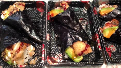 japanese sushi hand rolls in fancy disposable boxes used by restaurants for take-out