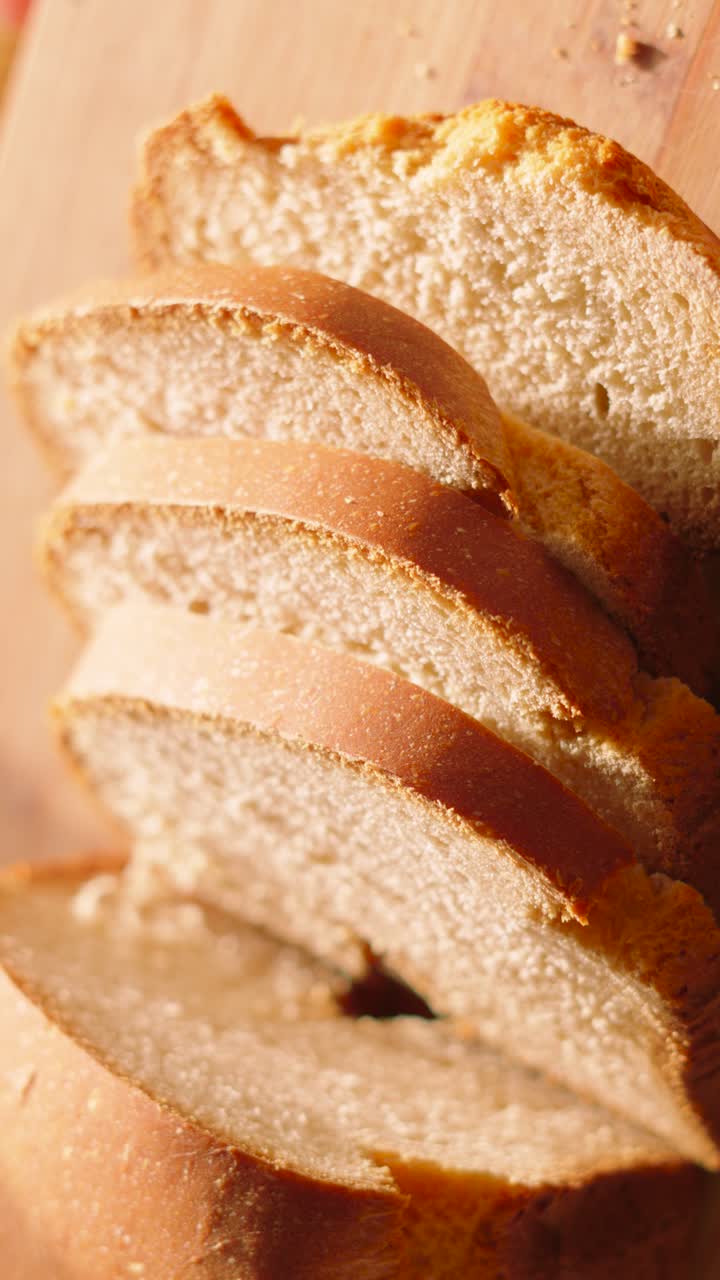 Vertical Video of Fresh Homemade Bread on Wooden Chopping Board in Early Morning Natural Lighting 4K.