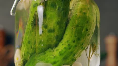 close-up of fermented cucumbers with garlic in can. preservation of vegetables in glass jars. fermentation preserved cucumbers with spices. russian cuisine.