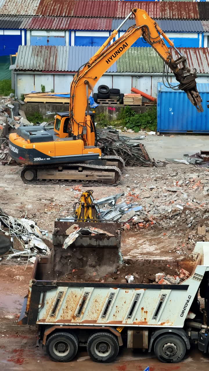 Demolition in progress. Excavators clear debris at a construction site, prepping the area for future development