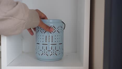 empty shelf with blue candle holder