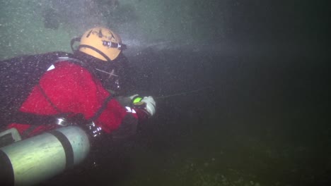 diver reels in the line on the way out of the wreck