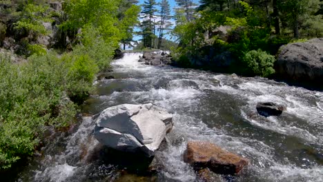 Fast-Rushing-Water-Flows-Around-A-White-Granite-Boulder-in-River-Rapids,-Fixed-Wide-in-4K-60fps