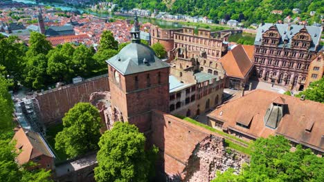 4k aerial drone video of ruins of historic castle on königstuhl hill overlooking heidelberg, germany