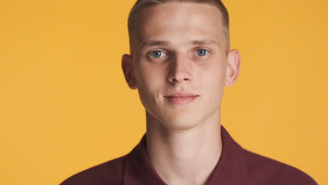 blond young man posing and smiling