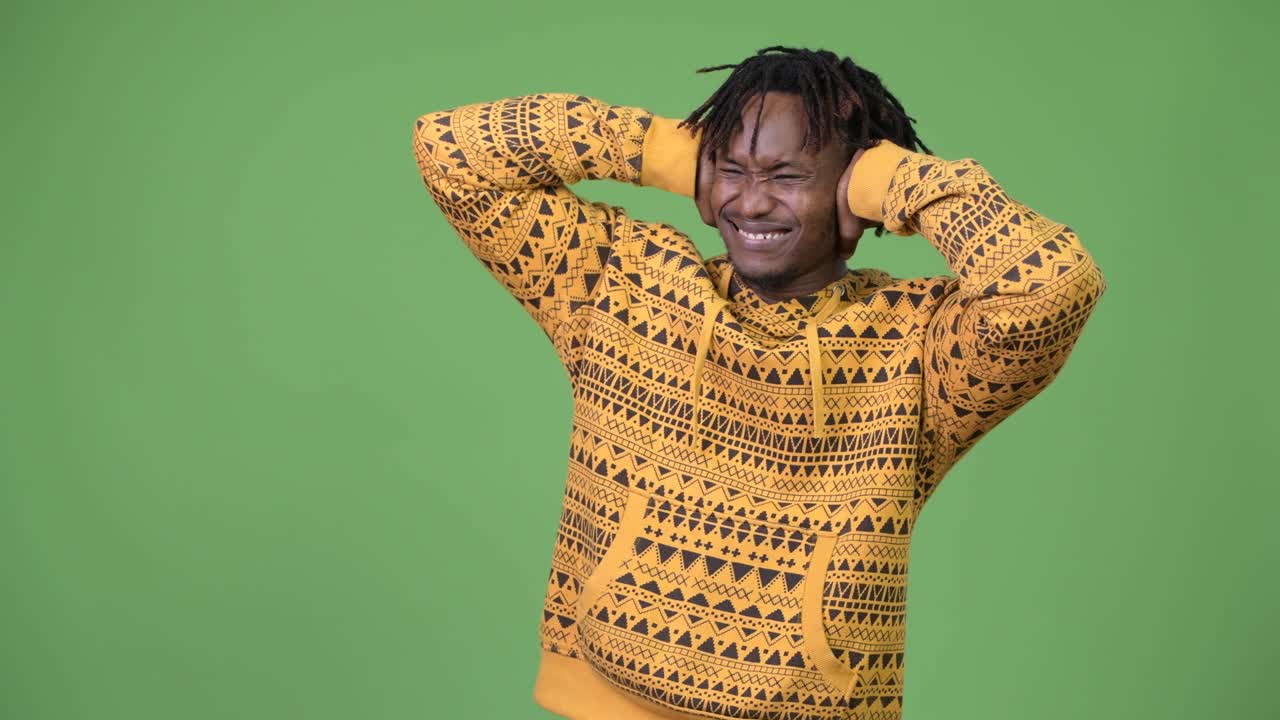 Young stressed African man covering ears from loud noise