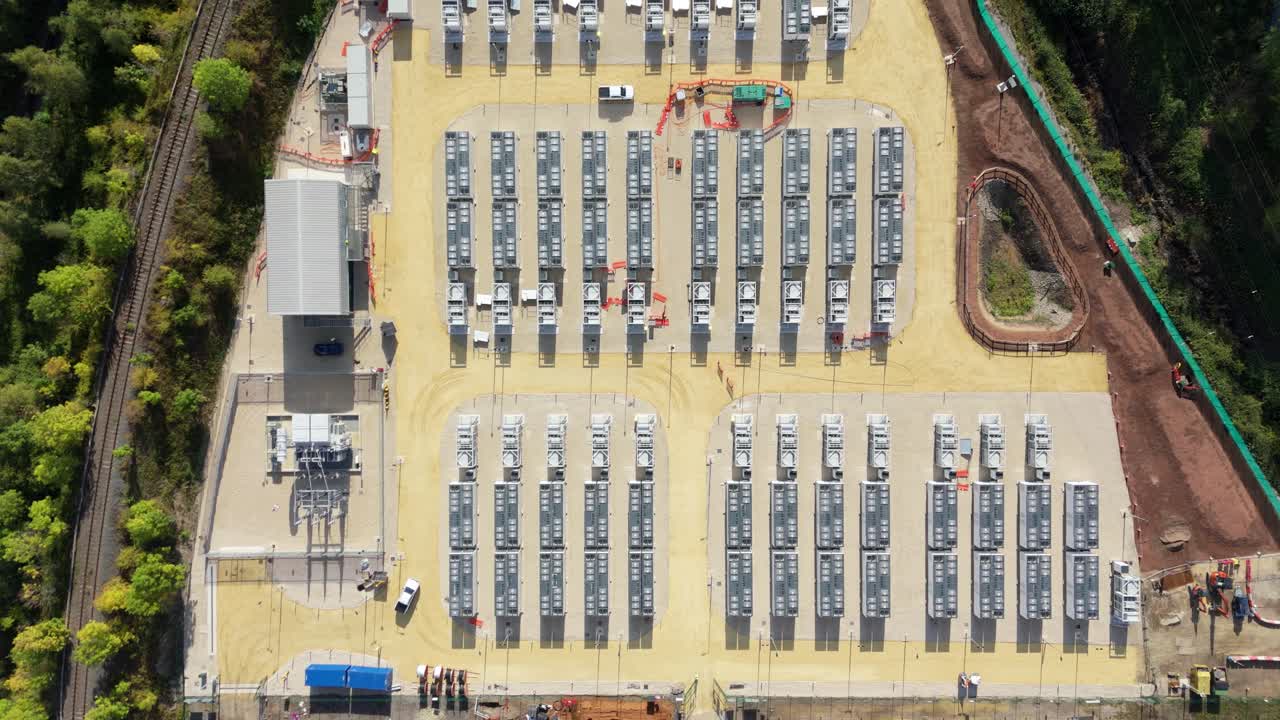 Top down aerial drone cinematic panorama of Ferrybridge battery energy storage facility with renewable electricity cells futuristic power plant in Yorkshire England UK