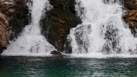 close up of a beautiful waterfall in glacier national park, running eagle falls named after a female warrior native american