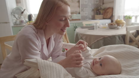 mother and baby bonding in kitchen