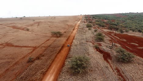 Aerial-over-cars-traveling-on-a-generic-rural-dirt-road-on-Molokai-Hawaii-from-Maunaloa-to-Hale-o-Lono