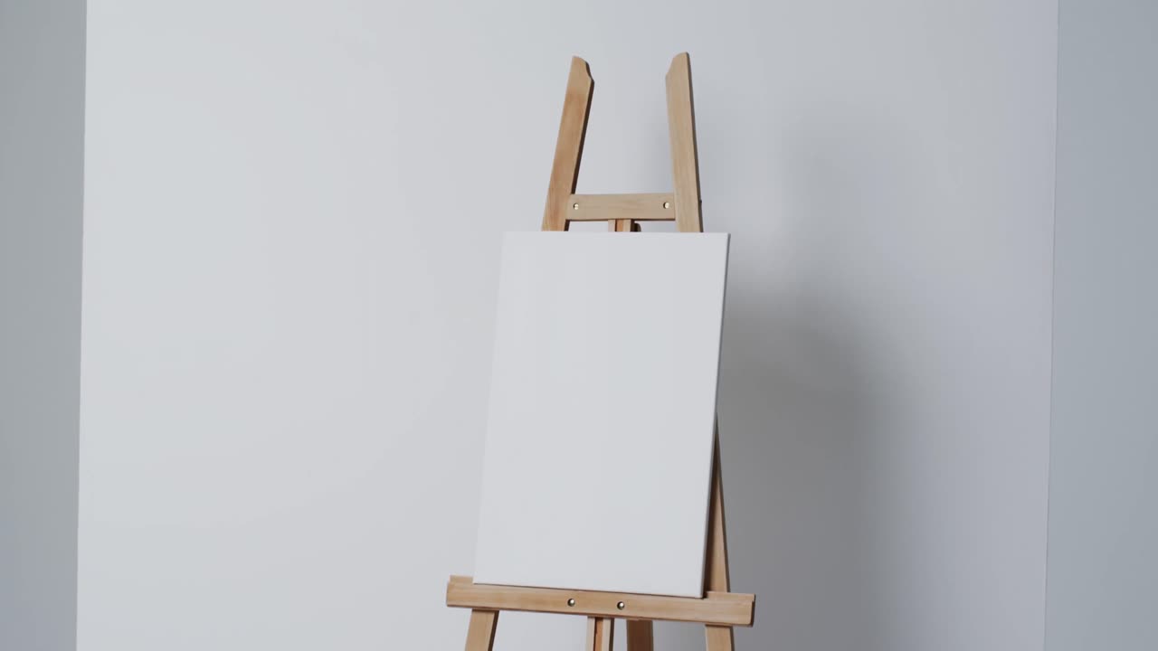 Video of white canvas sign on wooden easel with copy space on white background