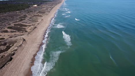 4K Aerial Drone Shot of Mediterranean Beach with Waves, Dunes, Vegetation, and People Walking with Dogs in Spain