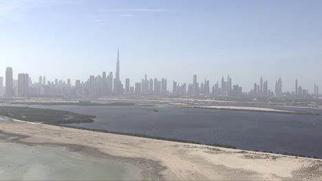 Aerial-establishing-shot-of-the-Burj-Khalifa-and-silhouette-skyline-in-Abu-Dhabi,-UAE